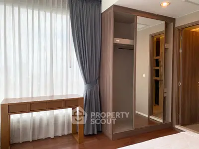 Modern bedroom with wooden furniture and large window with elegant curtains