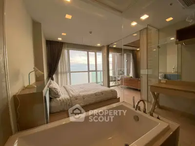 Luxurious bedroom with stunning ocean view and elegant bathtub, perfect for relaxation and comfort.