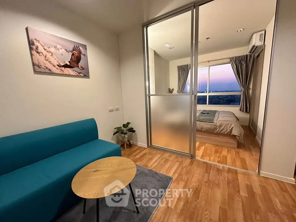 Modern apartment with cozy living room and bedroom, featuring stylish decor and sunset view.