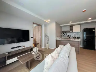 Modern open-plan living room with sleek kitchen and stylish decor