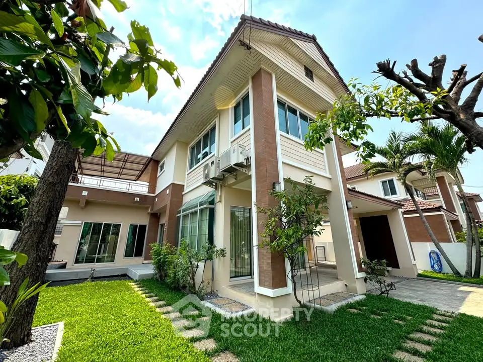 Charming two-story house with lush garden and modern architecture