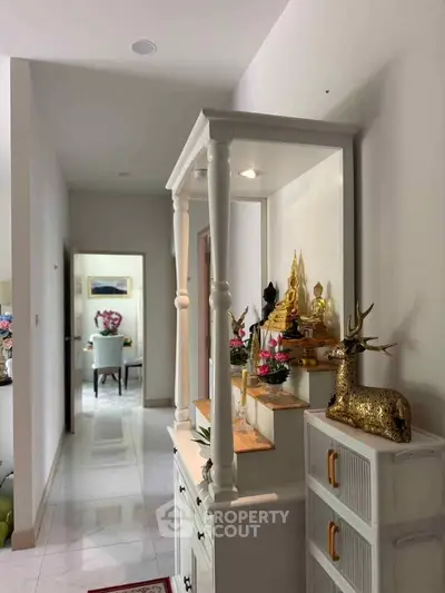Charming hallway with elegant decor and a glimpse into a cozy living area, perfect for modern living.