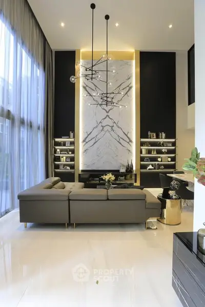 Luxurious modern living room with high ceilings and elegant marble accent wall.
