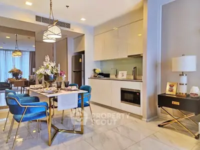 Luxurious open-plan kitchen and dining area with modern decor and elegant furnishings.
