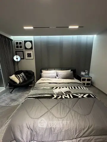 Modern bedroom with stylish decor and cozy ambiance, featuring a comfortable bed and chic furnishings.