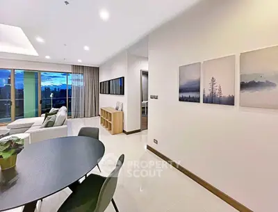 Modern living room with elegant decor and stunning city view from balcony.