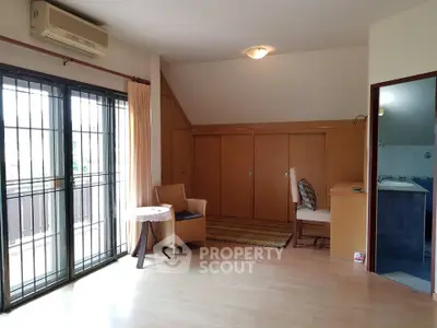 Spacious living room with natural light and balcony access in modern apartment.