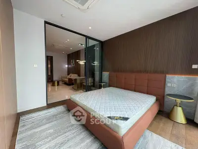 Modern bedroom with stylish decor and large glass sliding doors leading to a spacious living area.