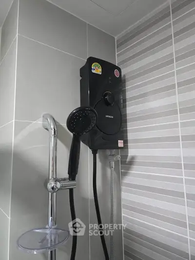 Modern bathroom with sleek showerhead and water heater, featuring stylish gray tile design.