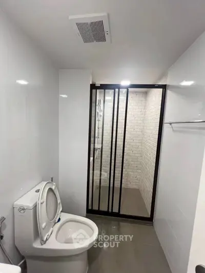 Modern bathroom with sleek shower enclosure and white tiles