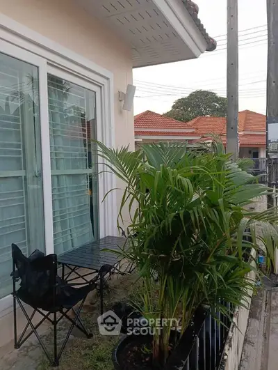 Charming small balcony with lush greenery and cozy seating area
