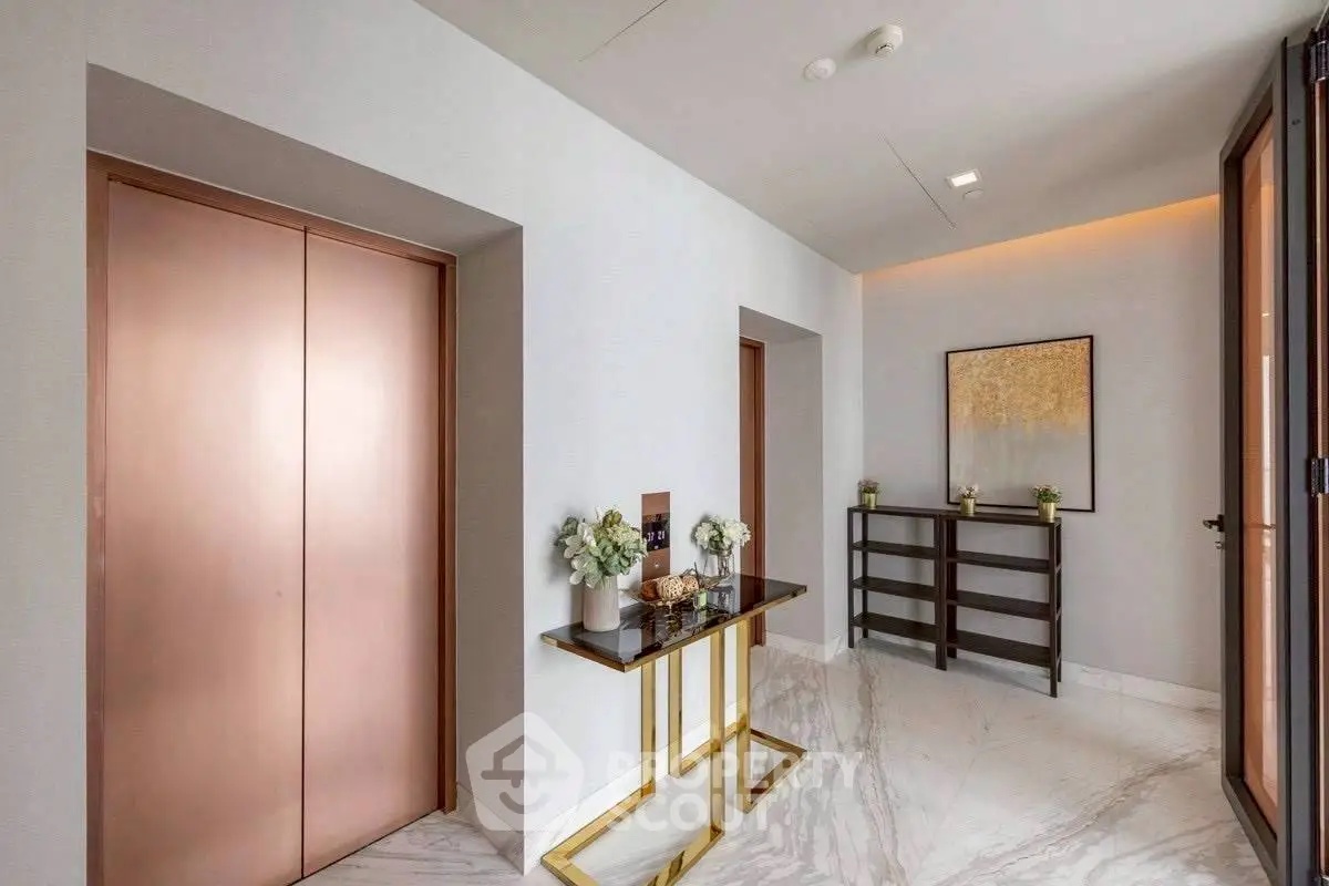 Luxurious apartment entrance with elegant decor and modern elevator access.