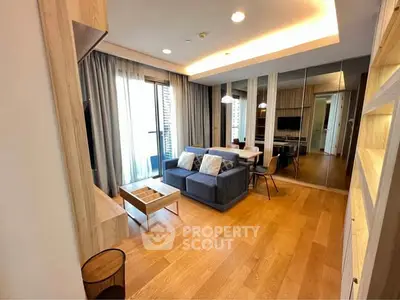 Modern living room with wooden flooring and stylish furniture in a cozy apartment.