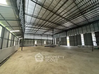 Spacious industrial warehouse with high ceilings and ample natural light