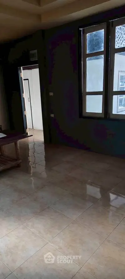 Spacious room with large windows and tiled flooring, perfect for customization.