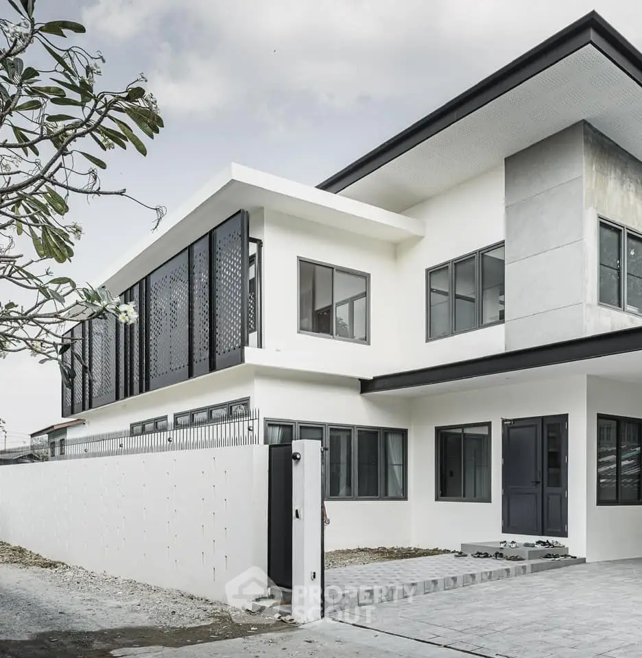 Modern minimalist two-story house with sleek design and large windows