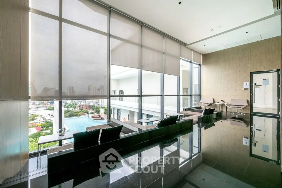 Luxurious modern living room with panoramic city view and sleek design.