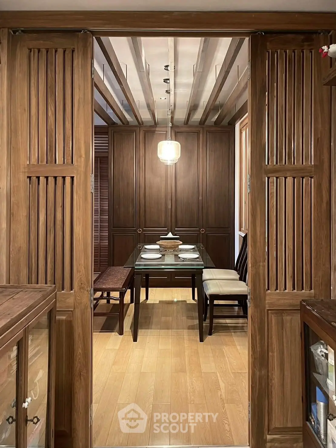 Elegant dining room with wooden accents and modern lighting, perfect for intimate gatherings.