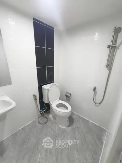 Modern bathroom with sleek white tiles and contemporary fixtures