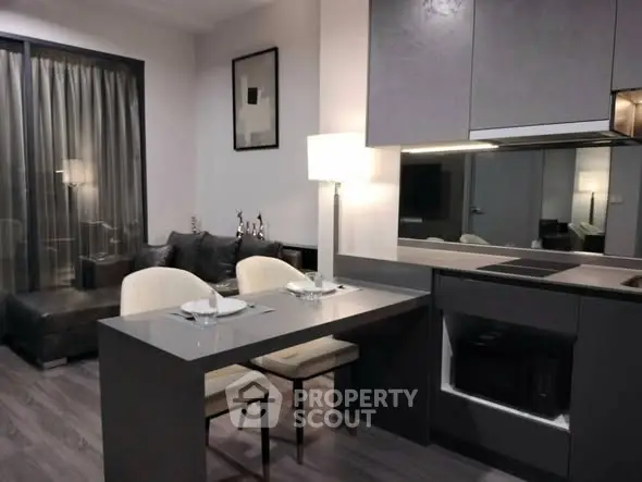 Modern open-plan kitchen and living area with sleek design and cozy seating.