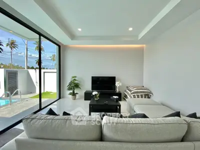 Modern living room with pool view and sleek interior design