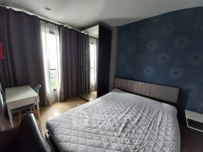 Cozy bedroom with modern decor and large window for natural light