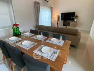 Elegant living and dining area with modern furniture and natural light