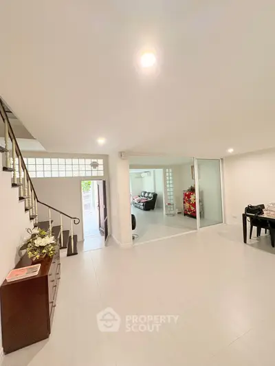 Spacious open-plan living area with modern decor and natural light