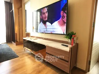 Modern living room with sleek TV stand and large flat-screen TV, perfect for entertainment.