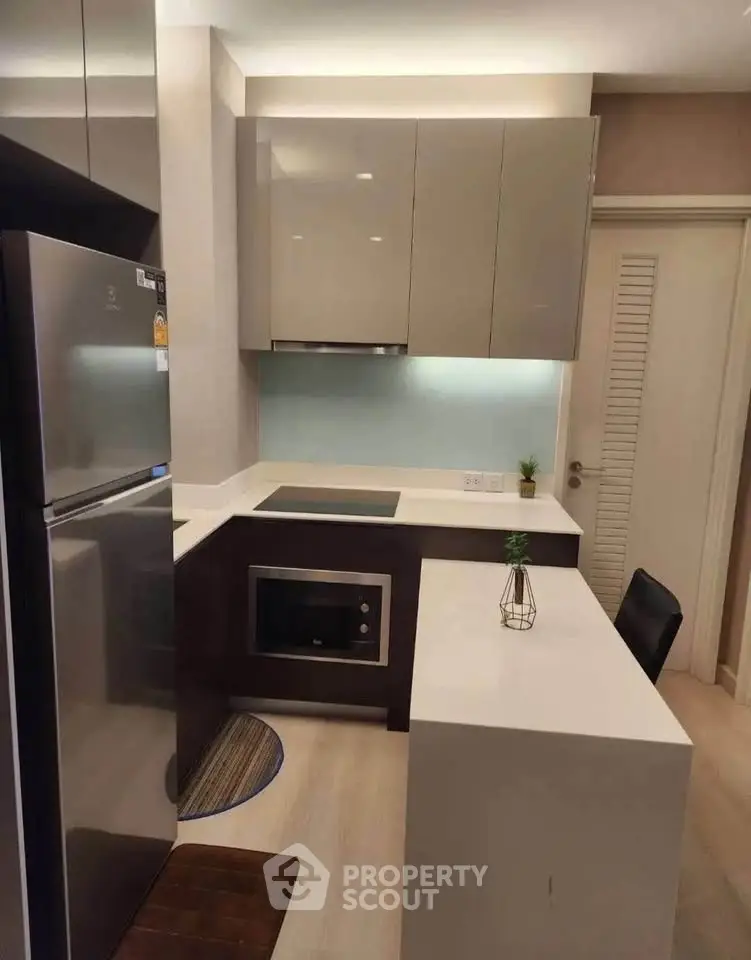 Modern kitchen with sleek cabinetry and built-in appliances in a stylish apartment.