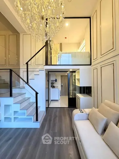 Luxurious duplex living room with elegant chandelier and modern staircase