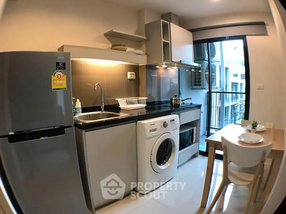 Modern kitchen with sleek appliances and dining area in a stylish apartment