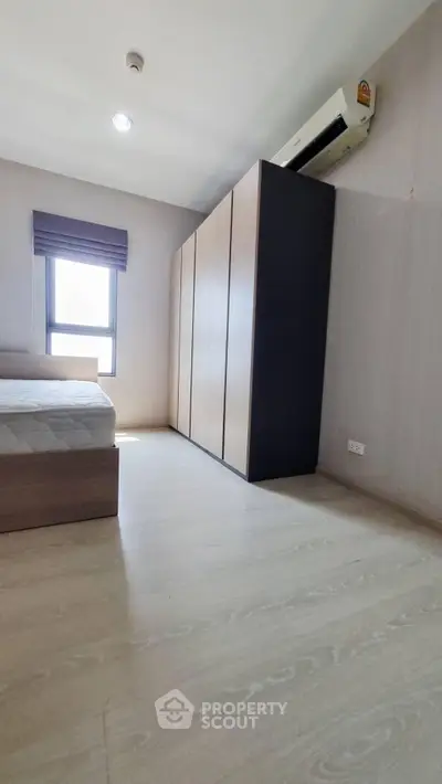 Spacious bedroom with modern wardrobe and natural light