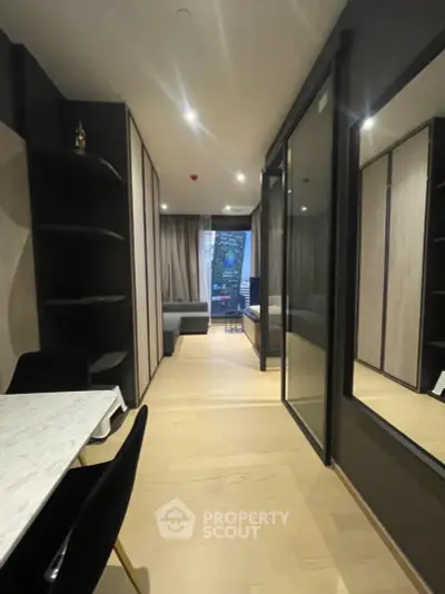 Modern apartment interior with sleek design and open layout, featuring a dining area and cozy living space.