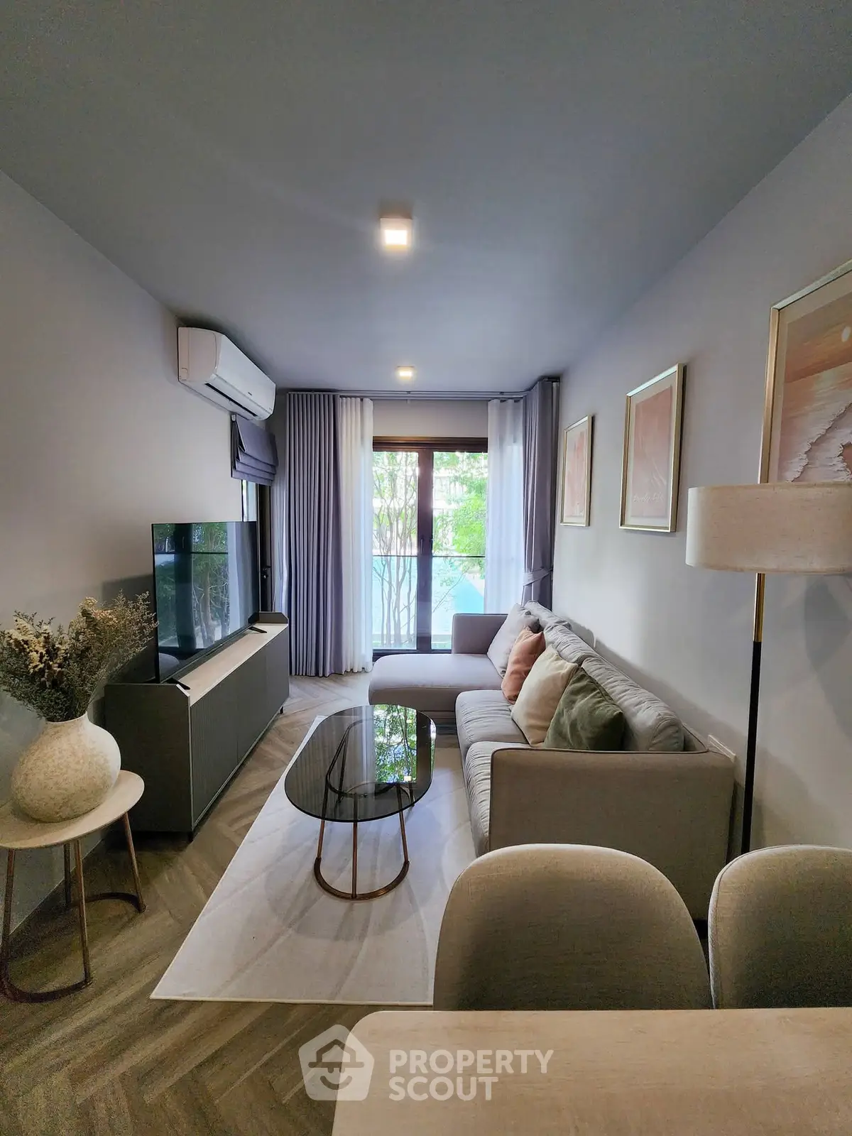 Modern living room with stylish decor and natural light, featuring a cozy sofa and elegant furnishings.