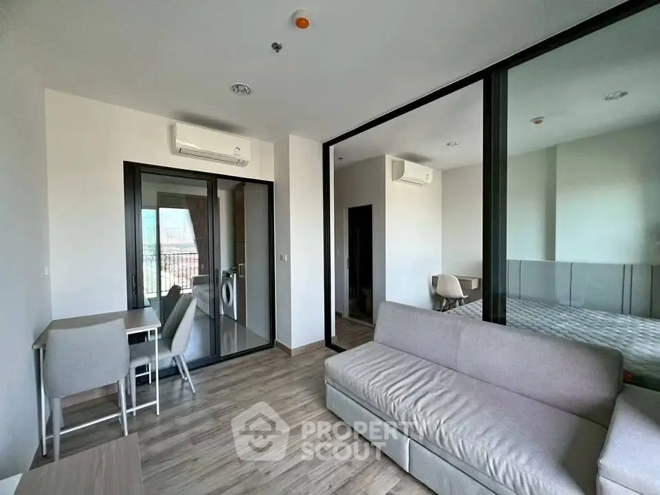 Modern living room with sleek design and large windows in a stylish apartment.