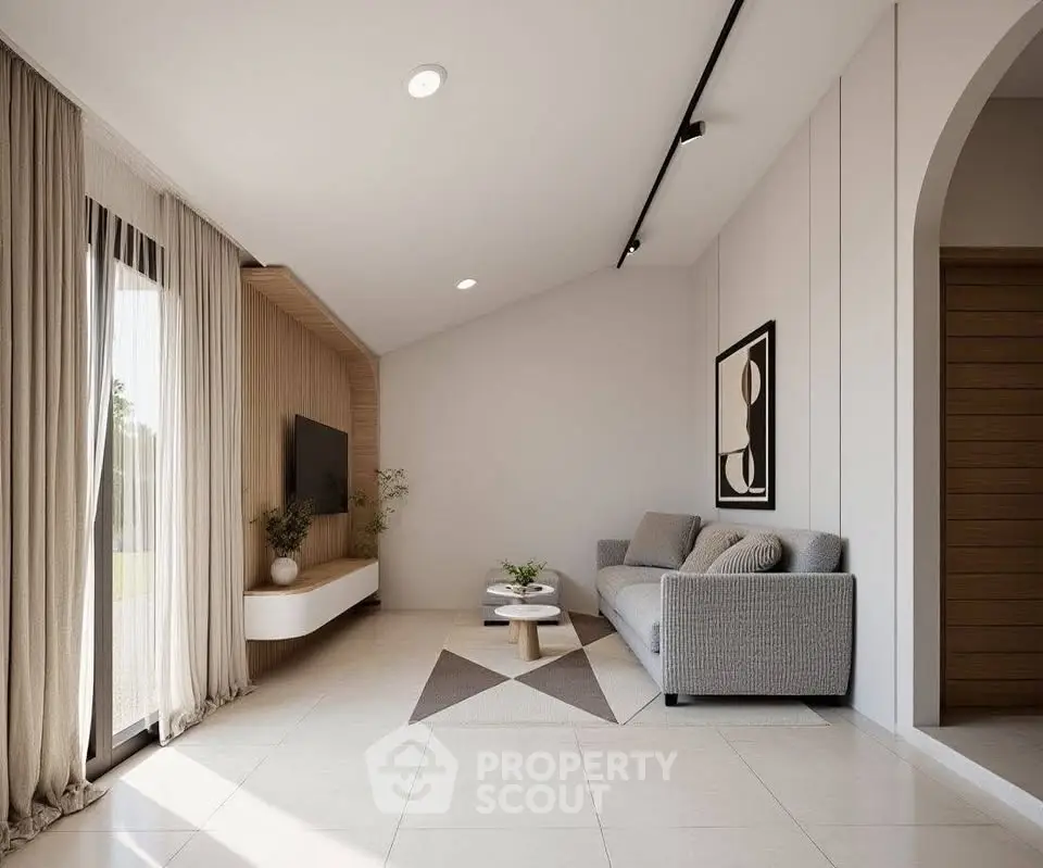 Modern living room with sleek design, featuring a cozy gray sofa, stylish decor, and large windows for natural light.