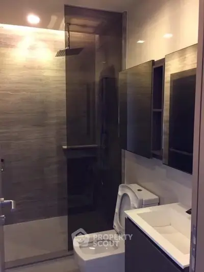 Modern bathroom with sleek design and glass shower enclosure.