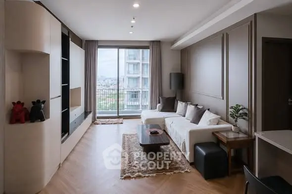 Modern living room with stylish decor and large window offering city view.