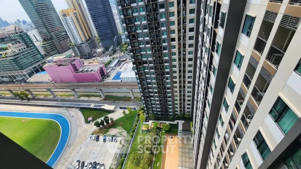 Stunning high-rise building view with lush green surroundings and cityscape backdrop.
