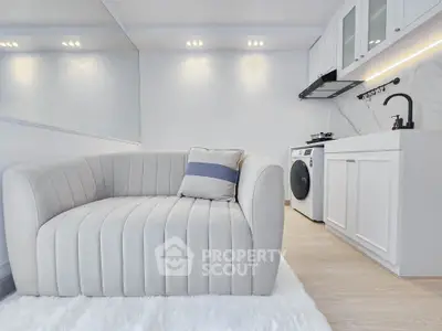 Modern living room with stylish sofa and compact kitchen area