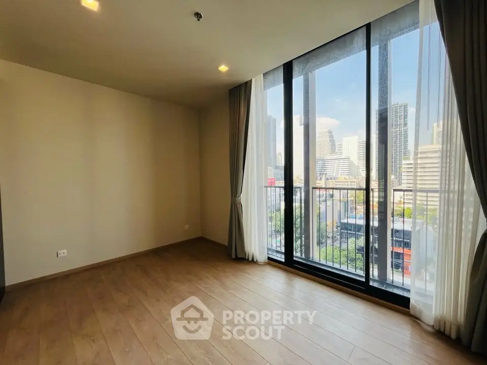 Spacious modern living room with city view and floor-to-ceiling windows