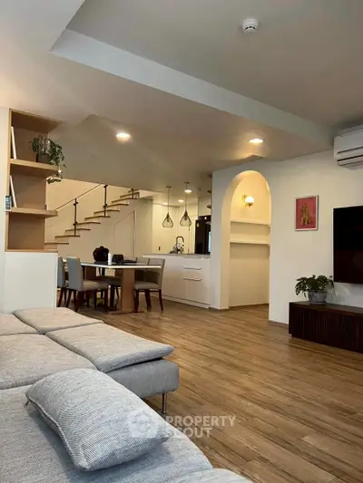 Spacious modern living room with open kitchen and stylish decor
