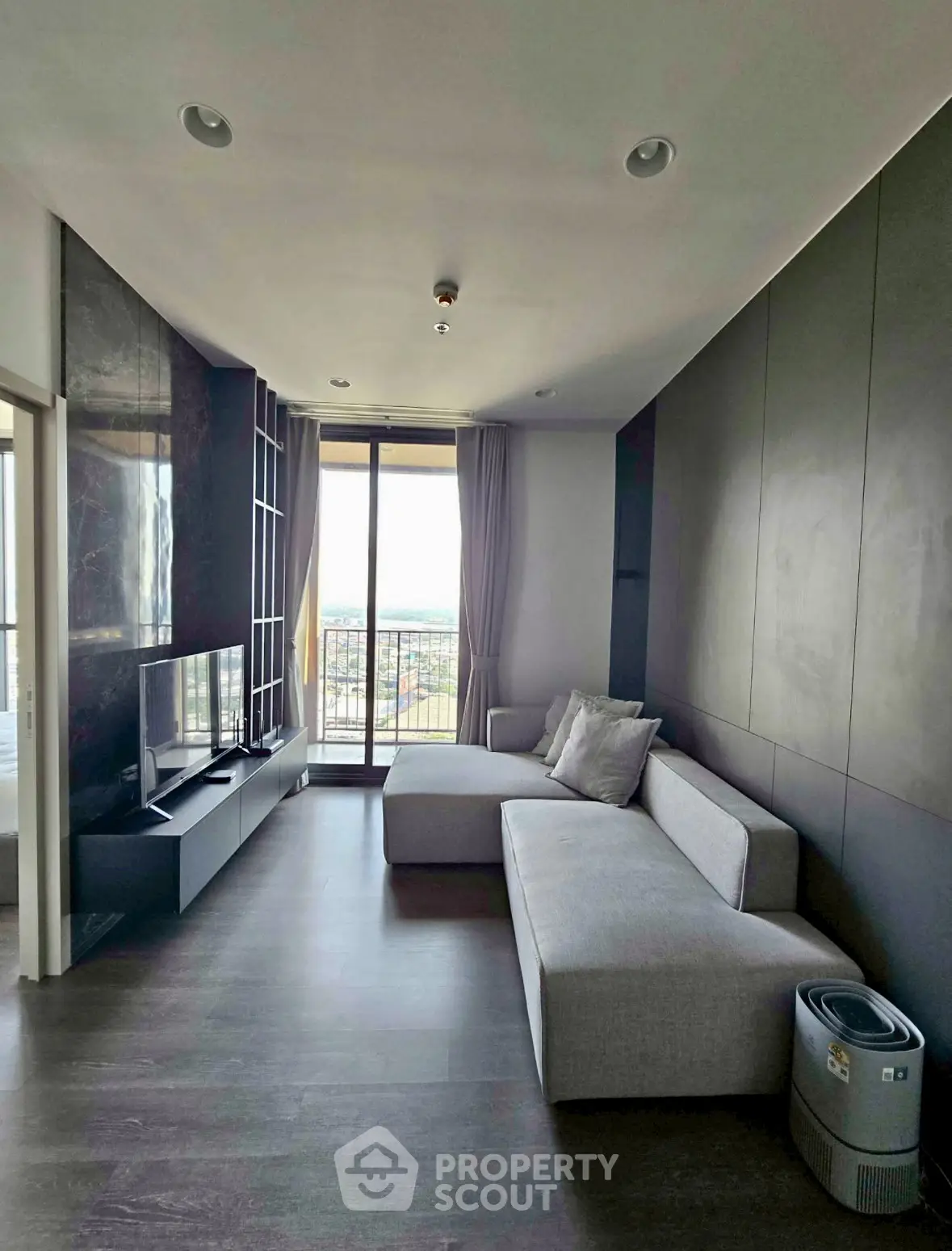 Modern living room with sleek design and large window offering city view