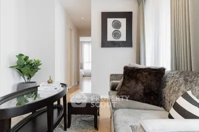 Elegant living room with plush sofa, stylish decor, and natural light in modern apartment.