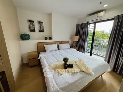 Cozy bedroom with balcony view and modern decor in a stylish apartment.