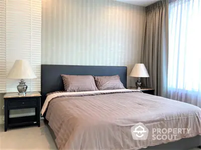 Elegant master bedroom with a large comfortable bed, stylish bedside tables, and soft ambient lighting from classic lamps, perfect for a restful retreat.