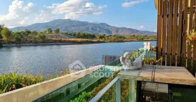 Stunning riverside balcony with mountain views, perfect for relaxation and enjoying nature.
