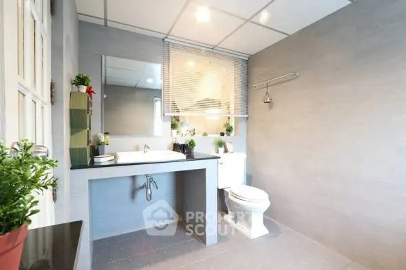 Modern bathroom with sleek design and ample natural light