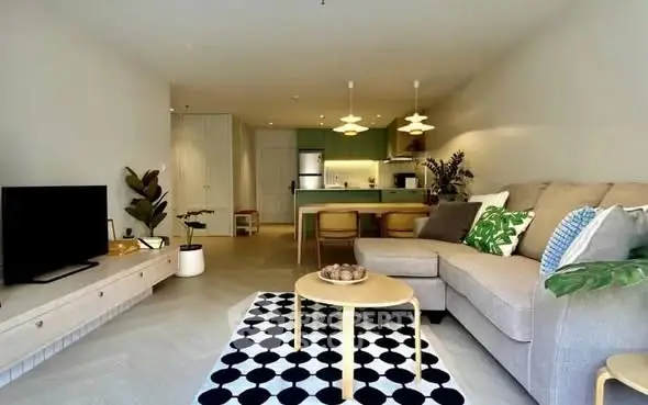 Modern living room with stylish decor and open kitchen layout in a cozy apartment.